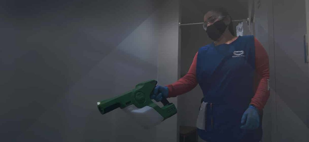 A Janitor doing disinfection